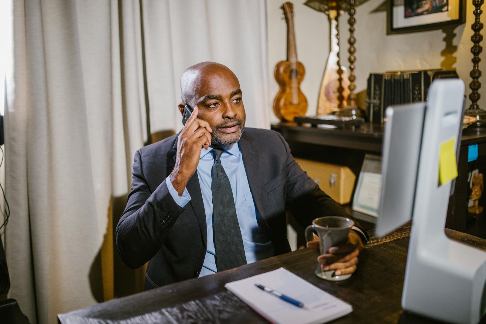 Business professional in a home office setting on phone, working remotely.